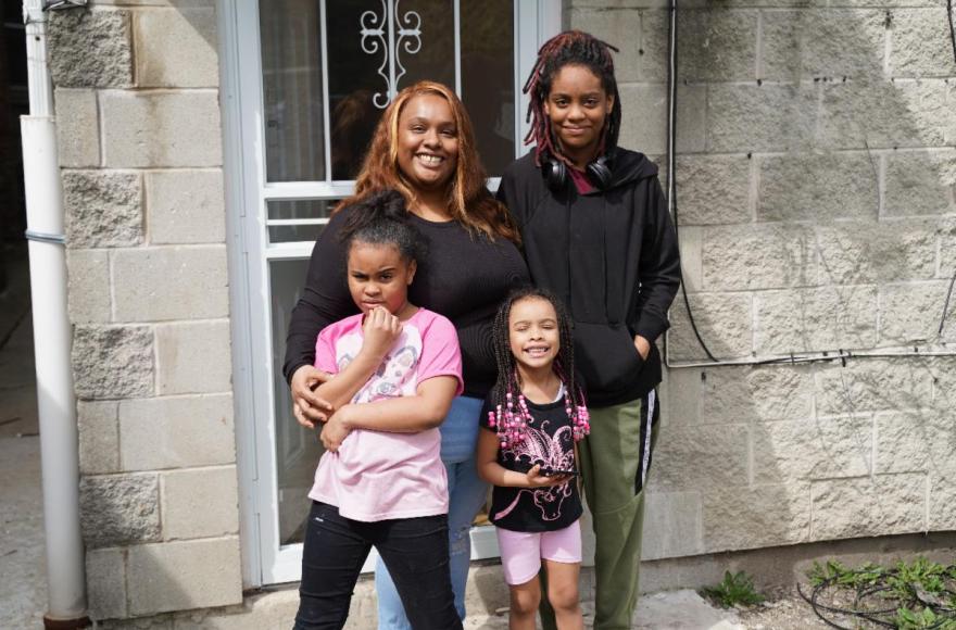 CHA Resident Shavon Nowell and her children at their new home